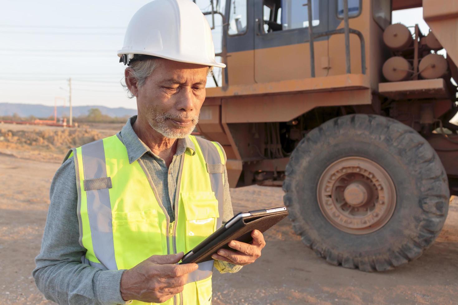 A senior mining engineer enjoys his work in the evening sun. photo