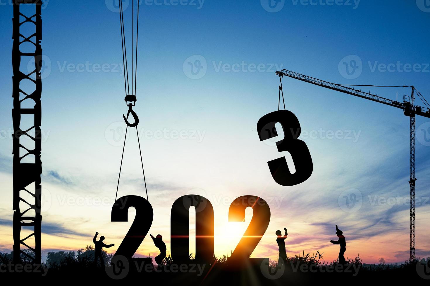 Silhouette of construction worker with crane and cloudy sky for preparation of welcome 2023 new year party and change new business. photo