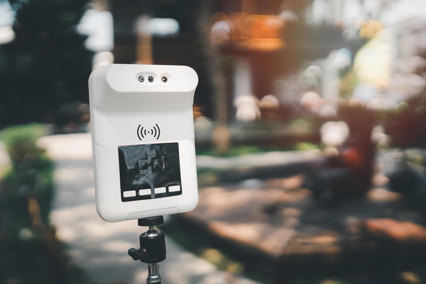 Digital thermometer for measuring body temperature by placing a hand over the sensor in a cafe checks of customers during the Covid-19 pandemic. photo