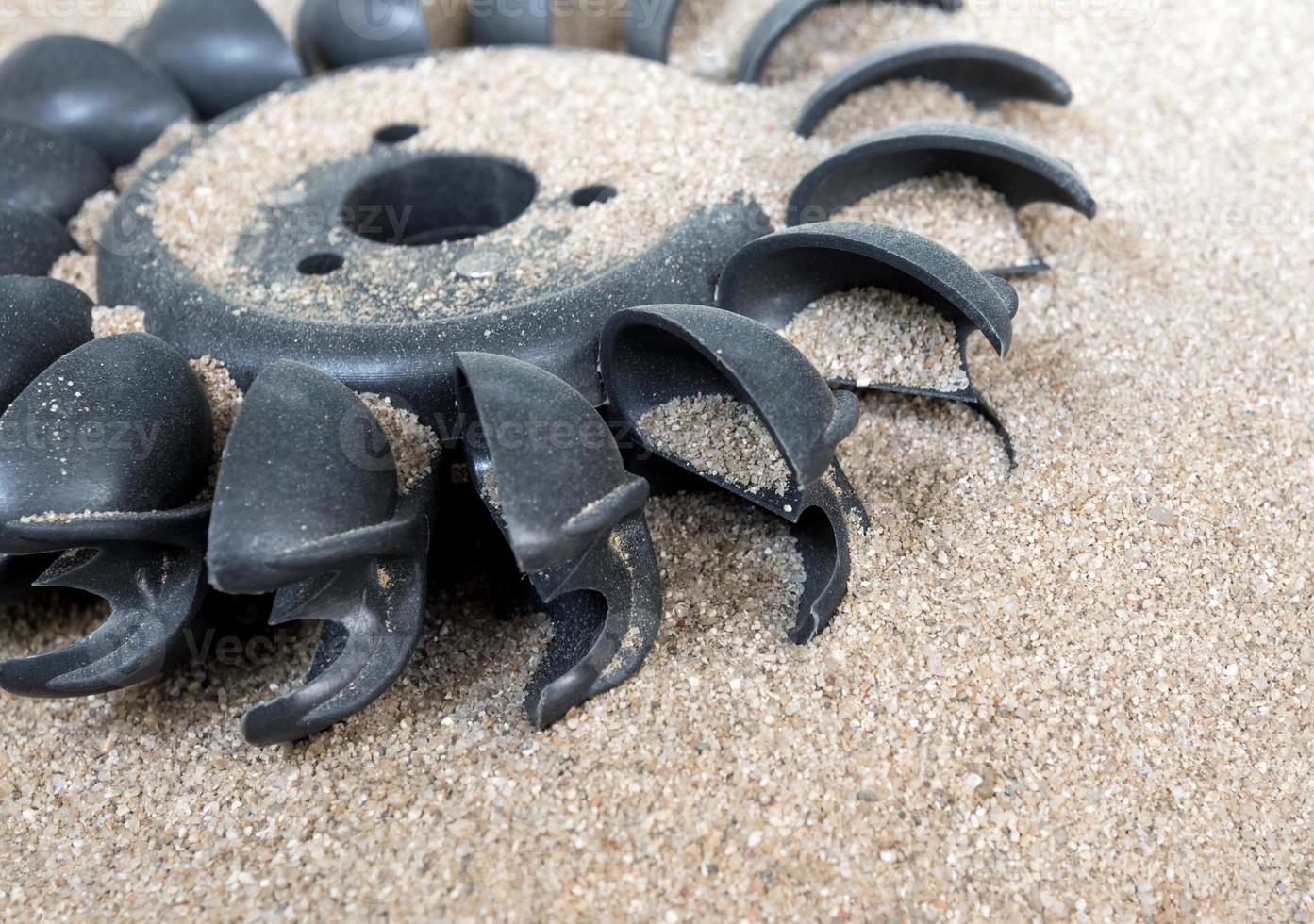 Plastic Pelton water turbine on sand with out water photo