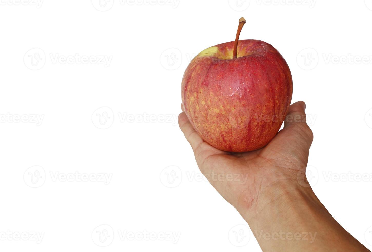 Red apple with water droplets in the hand of a young man isolated on white background with clipping path. photo