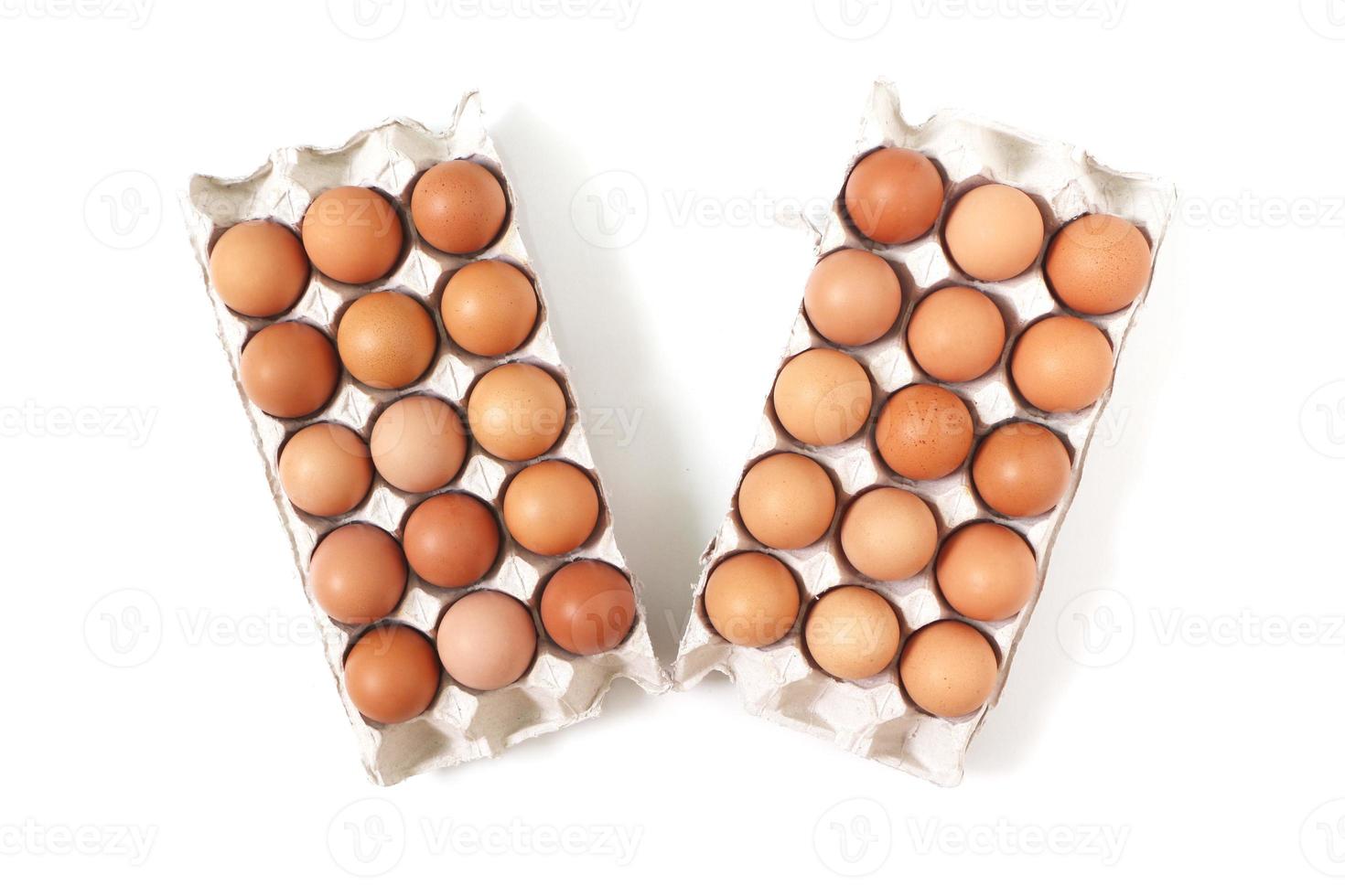 Eggs of chicken in paper tray on white background. Top view. photo