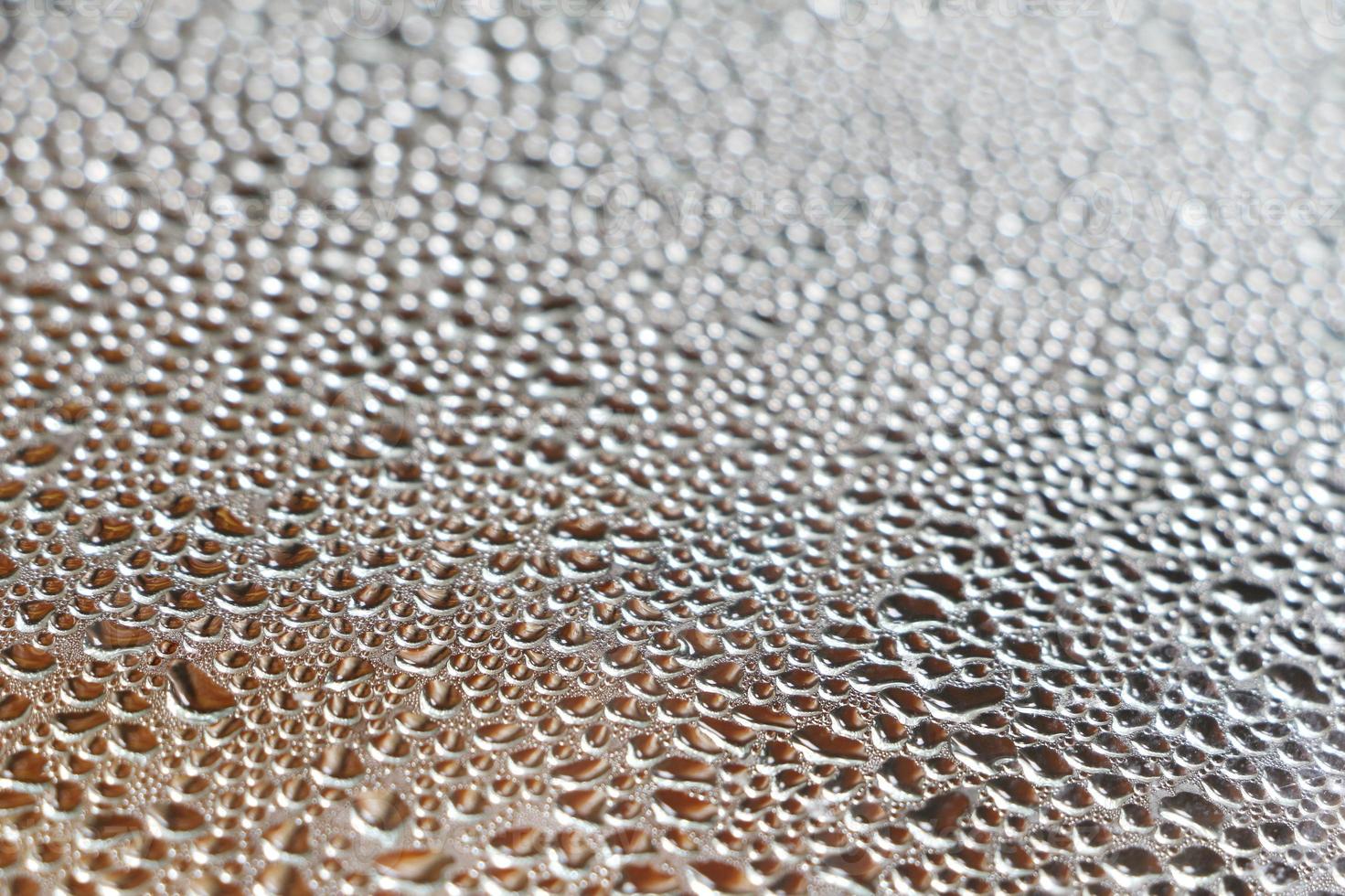 Selective focus of water droplets on the window glass. Abstract background of blurred raindrops. photo