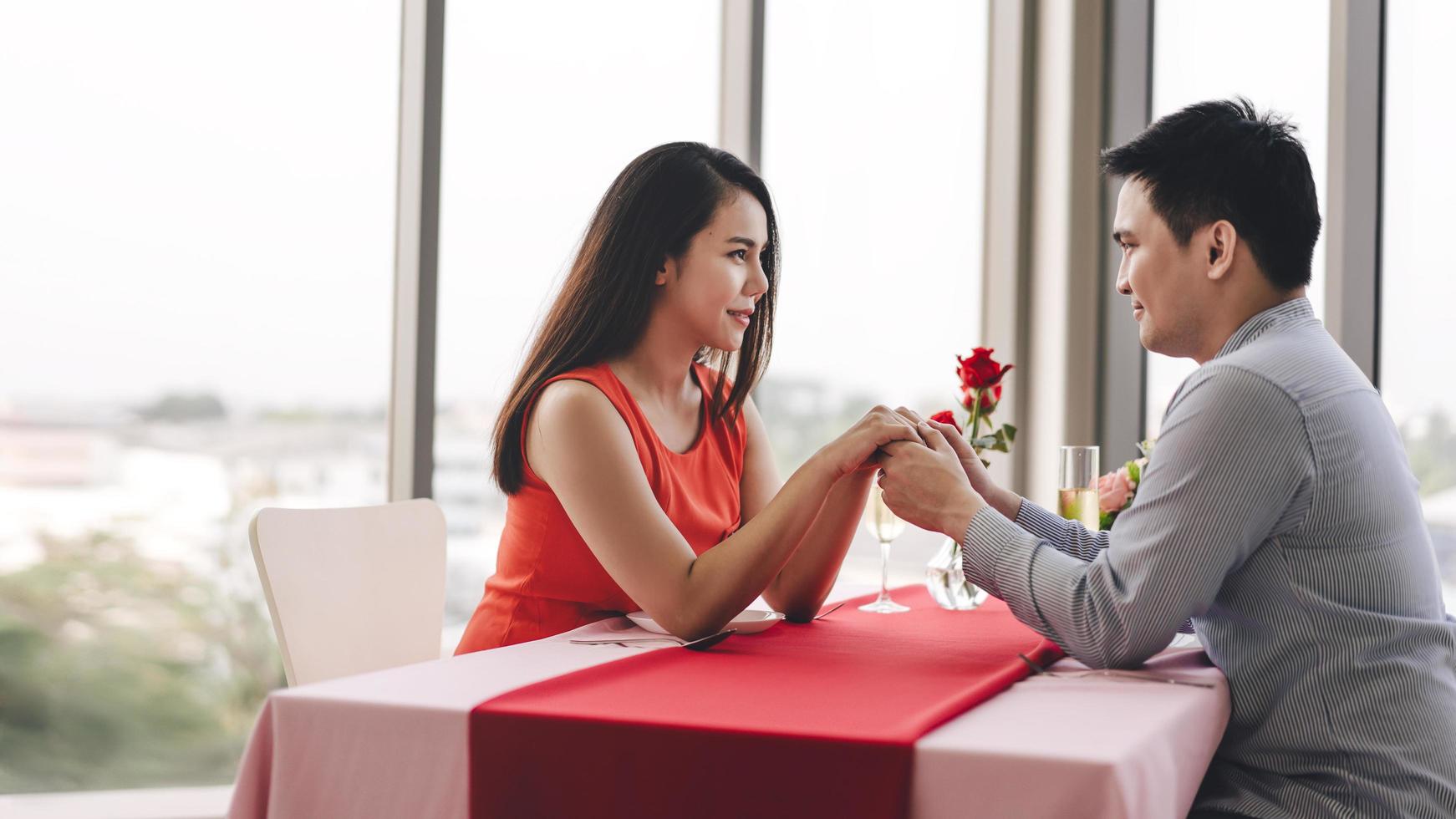 Smile adult asian lover couple man and woman hand hold together on valentine date. photo