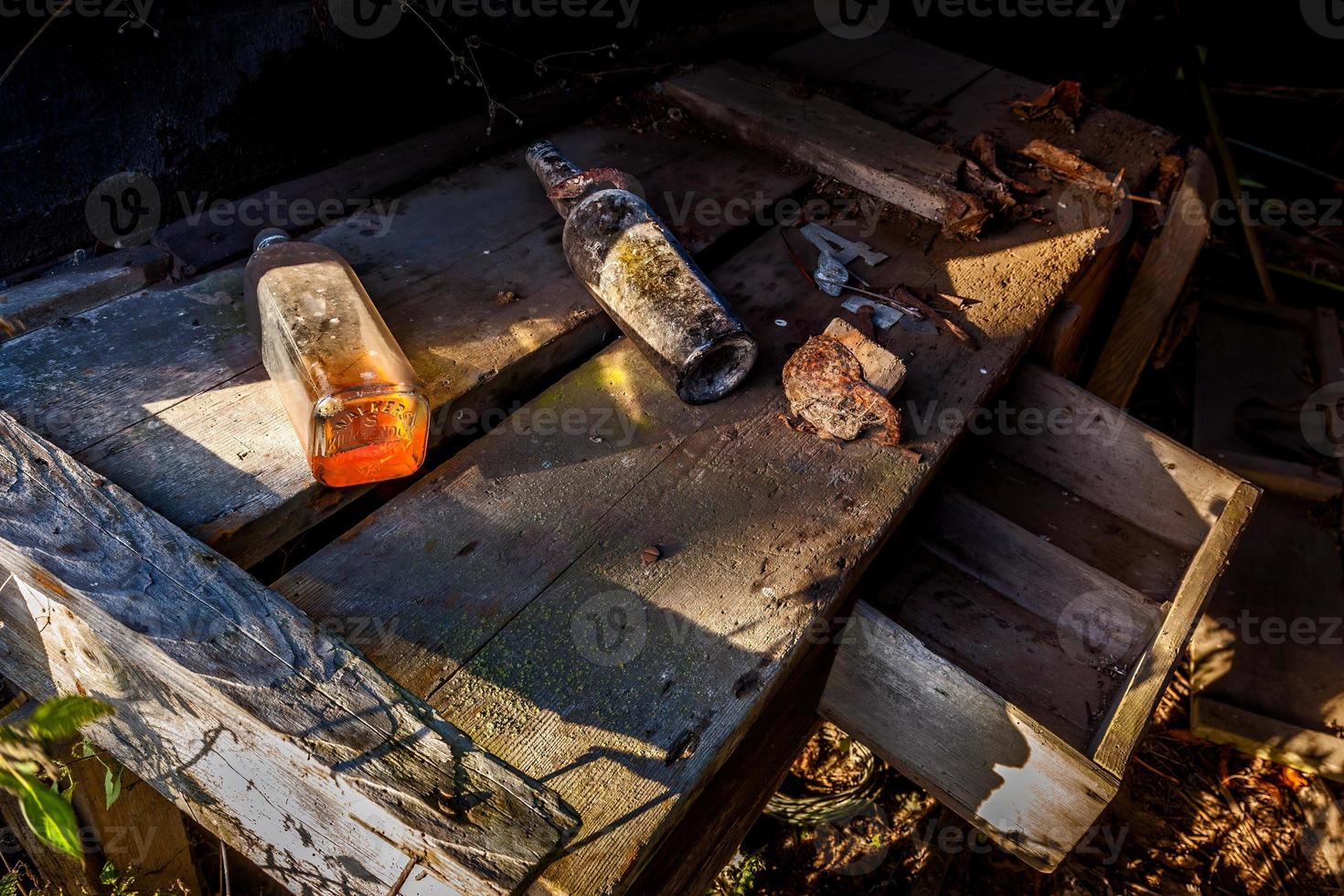 Bottles on a bench in a derelict building photo