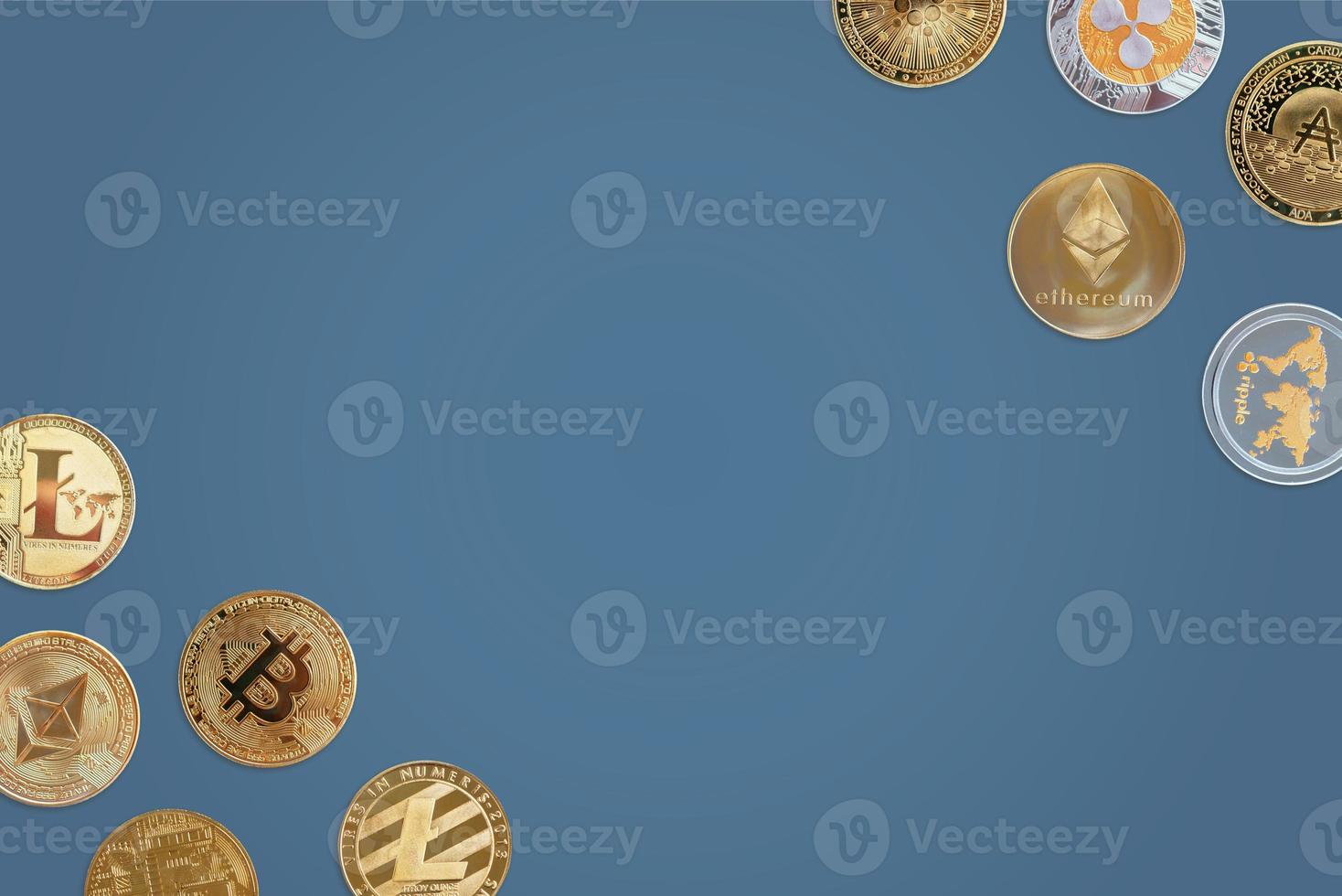Crypto coins on blue desk with copy space in the middle. Top view, flat lay background photo