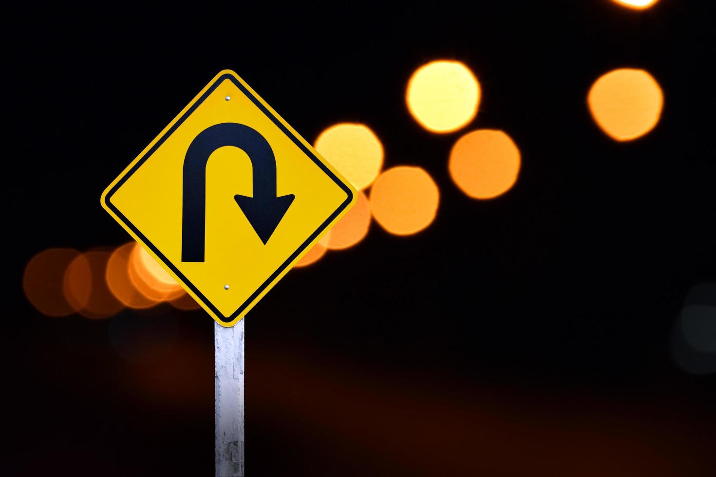 Right turn sign on white pole with clouds and blue sky background. photo