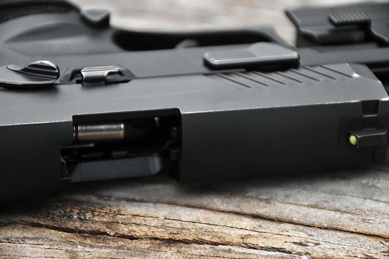 Closeup view of 9mm automatic pistol chamber which is holding in hand, selective and soft focus. photo