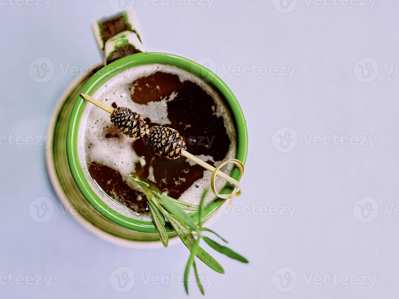 Warm strong alcohol cocktail with syrup with rosemary and bump on a top in the cup photo