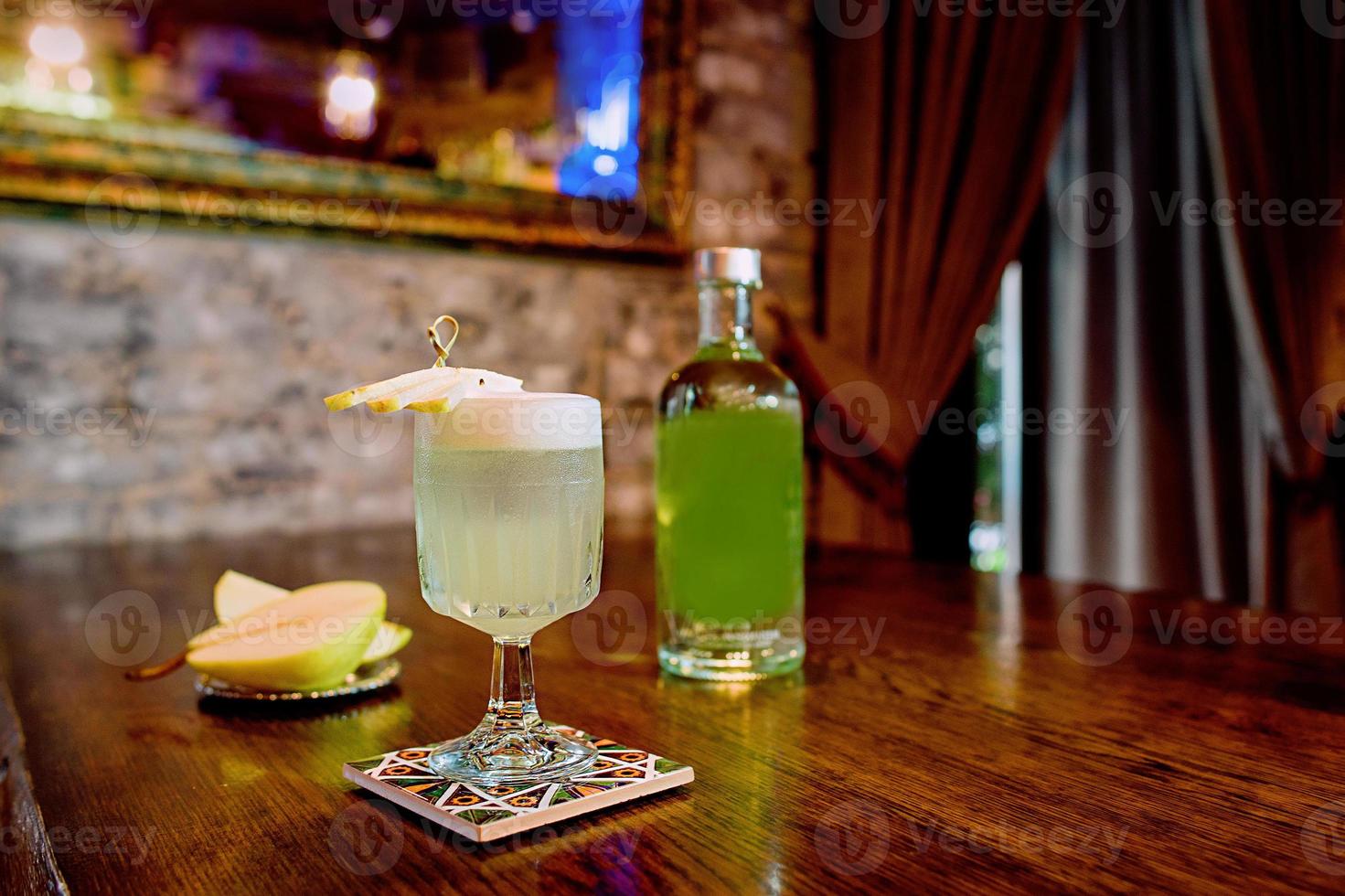 italian pear cocktail with pear and liquor on the table photo