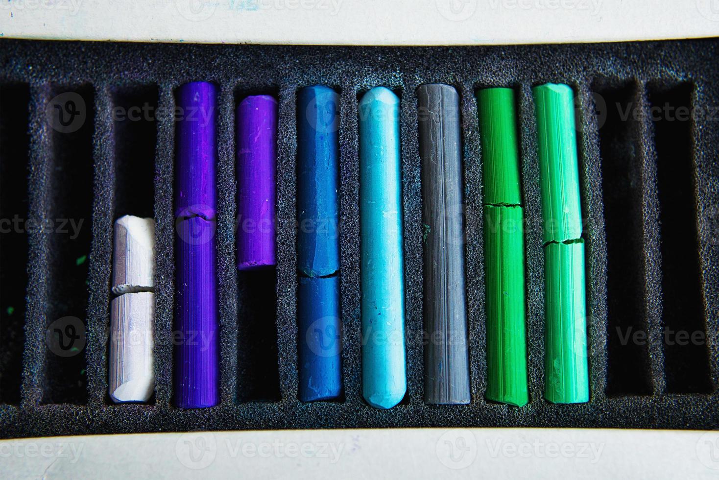 Pieces of colorful pastel chalks in the box photo