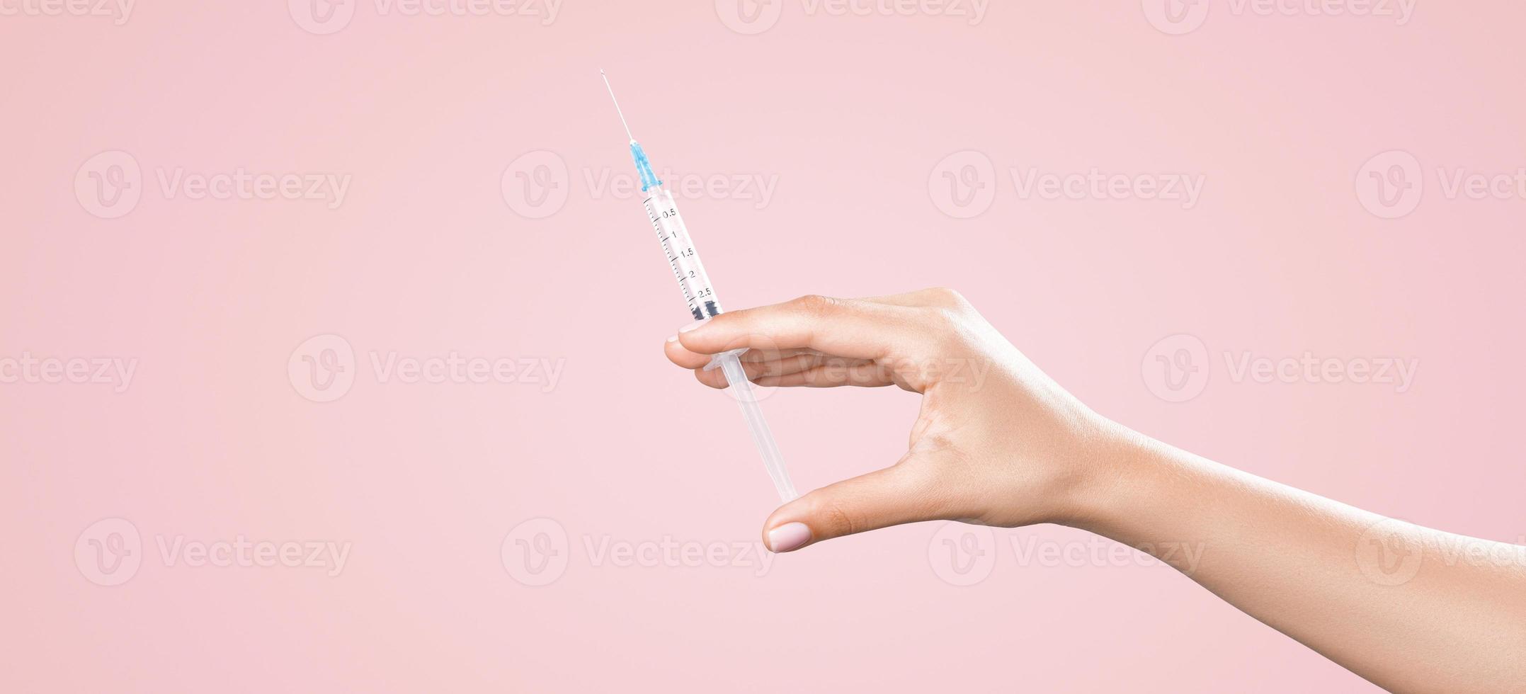 Hand holding syringe with vaccine against corona virus. photo