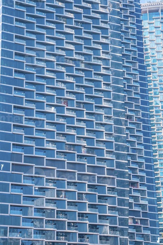 Full frame view of glass windows and balconies of residential tower photo