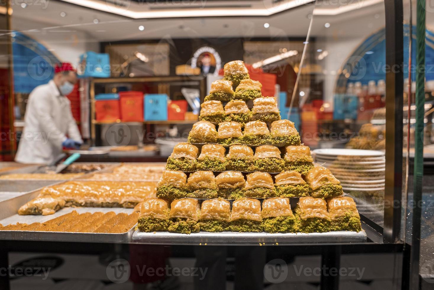 Baklava sweet pastry made of filo filled with chopped nuts display in tray photo