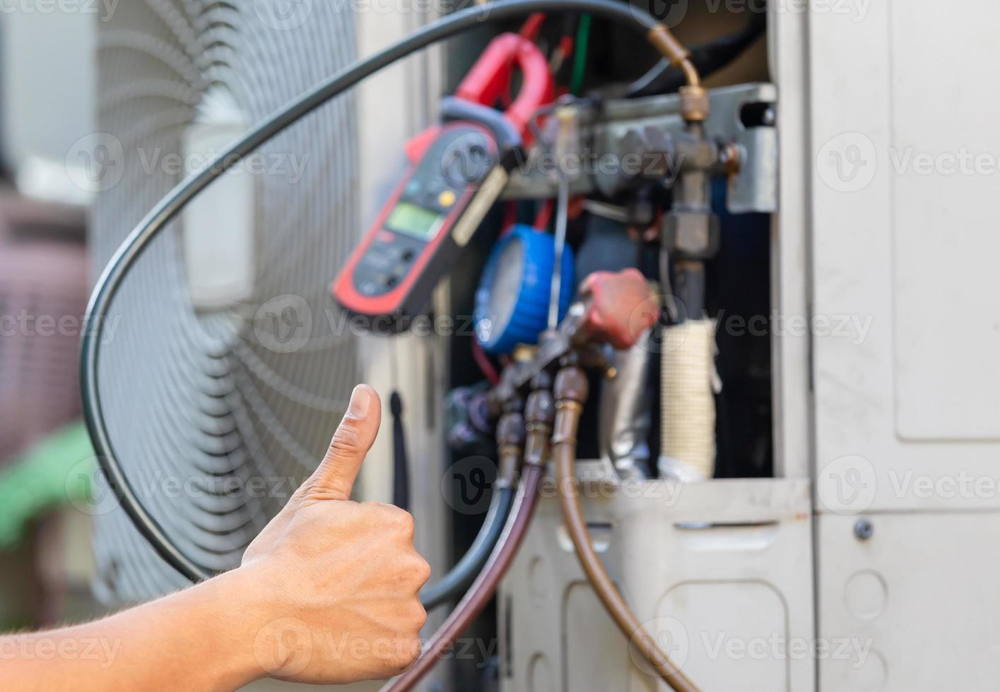 Close up of Air Conditioning Repair, repairman on the floor fixing air conditioning system photo