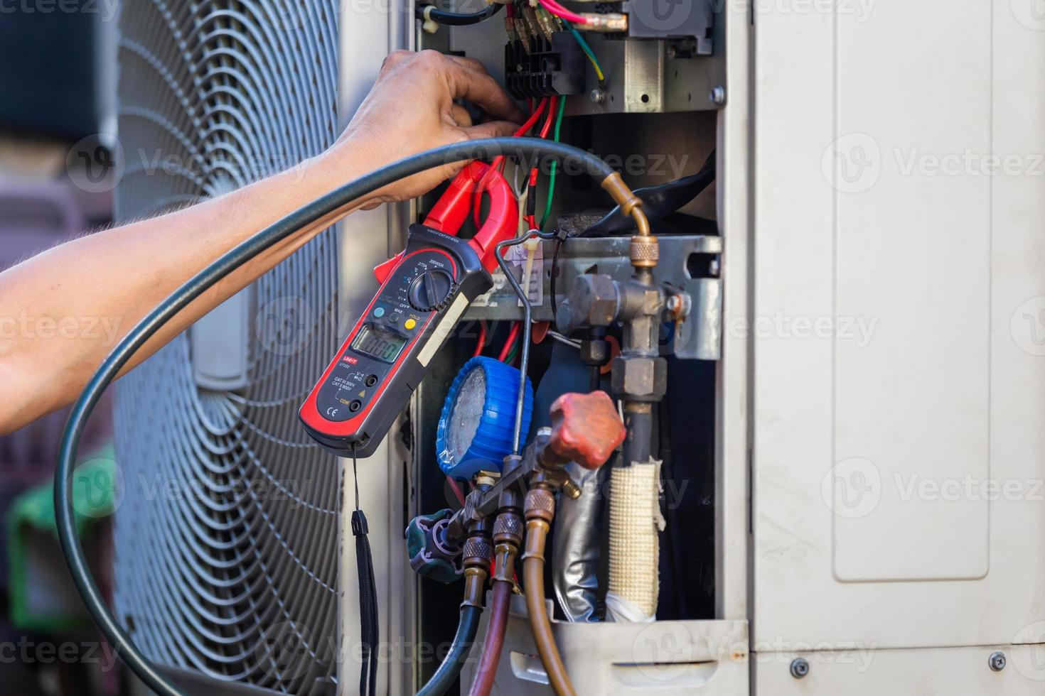 Air Conditioning Repair man hands checking and fixing modern air conditioning system, Technician team checking leakage air conditioning system photo