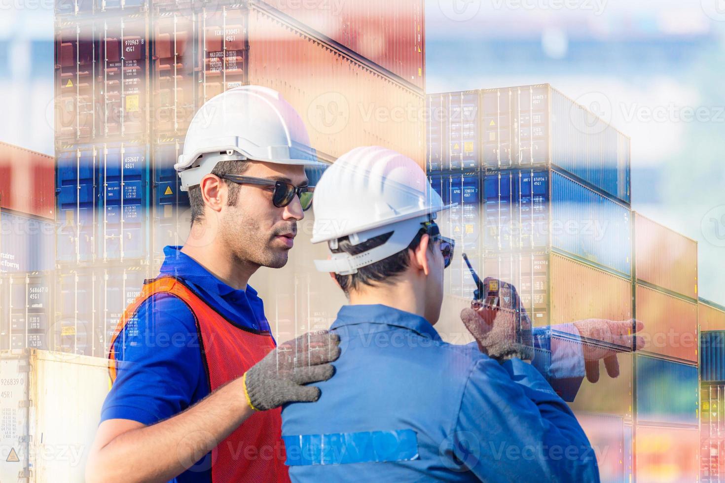 Engineer and Worker man in hardhat and safety vest checking control loading containers box from cargo, Teamwork concept photo