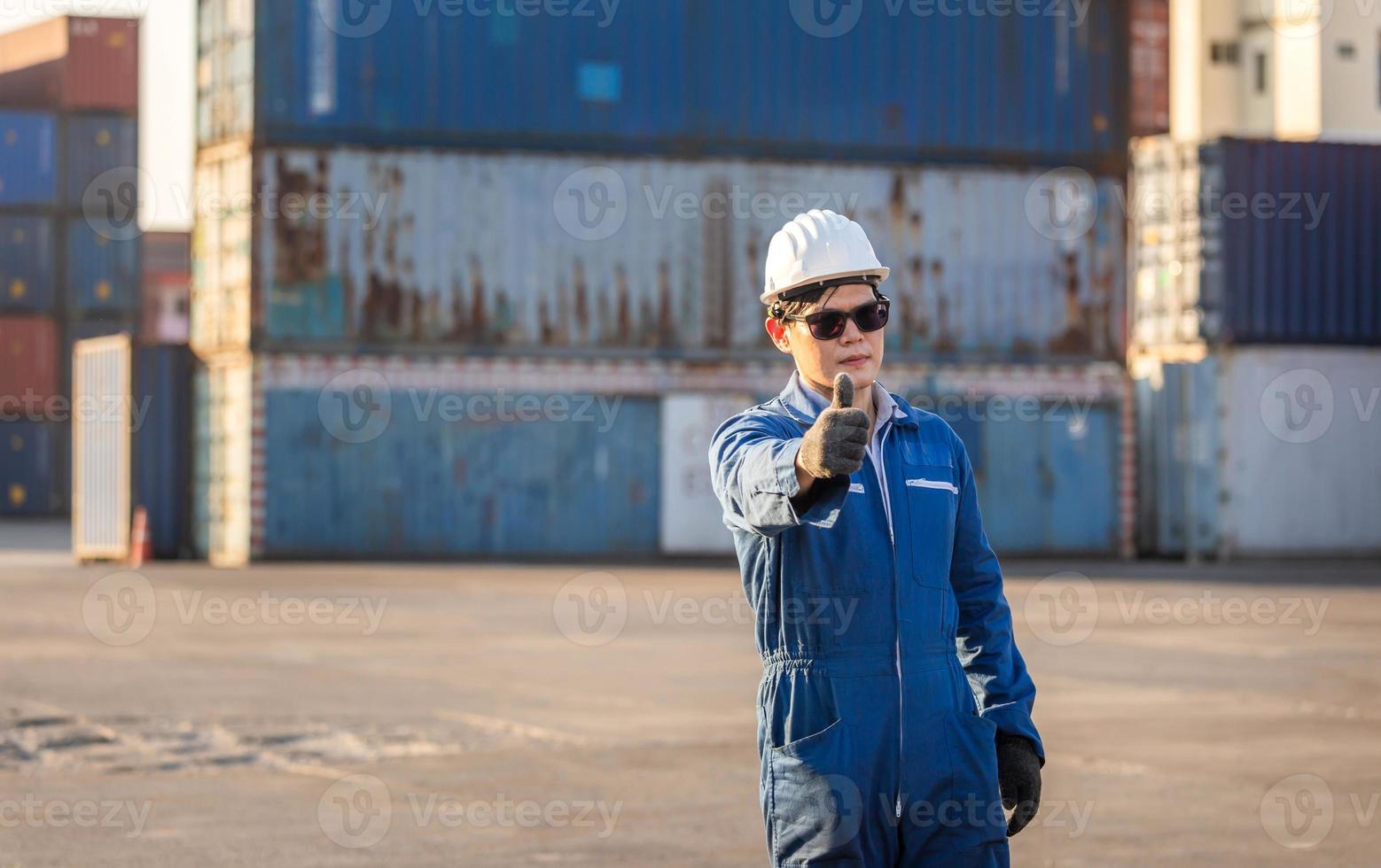 Cheerful factory worker man smiling with giving thumbs up as sign of Success photo