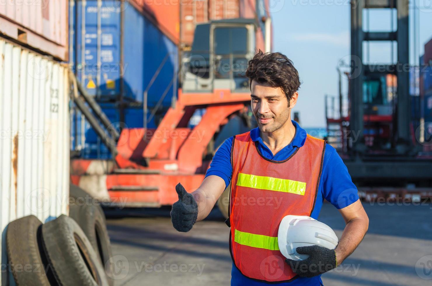 Cheerful factory worker man smiling with giving thumbs up as sign of Success photo
