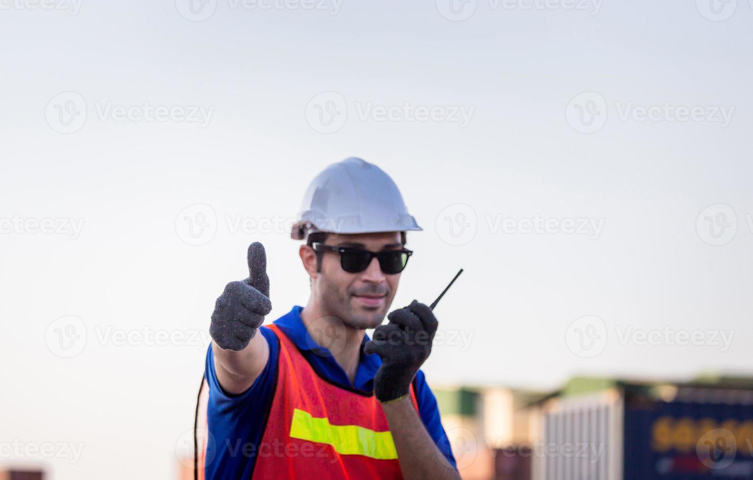 Cheerful factory worker man smiling with giving thumbs up as sign of Success photo