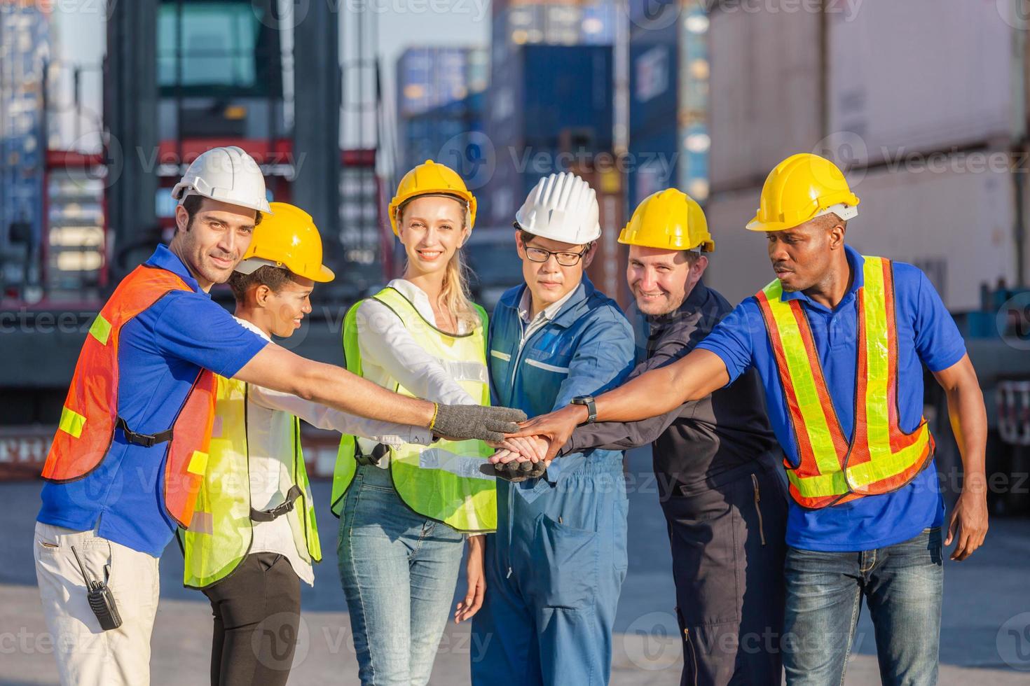 Success and Happiness Teamwork Concept, Business people group, engineer and worker team joining hands with blurred cargo containers background photo