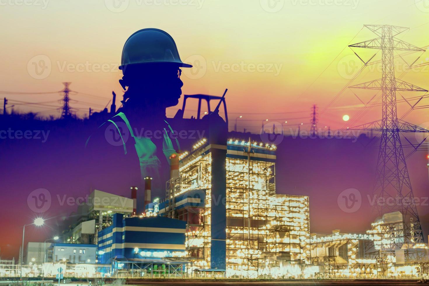 Double exposure of the shadow of an engineer working in a white helmet. Radio communication in a power plant at sunset photo