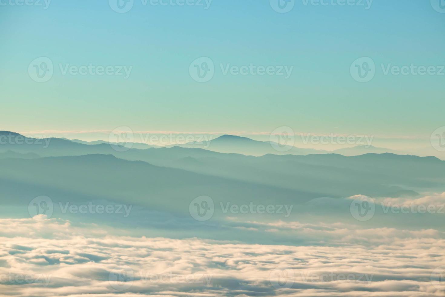 Foggy valley misty mountains at sunrise photo