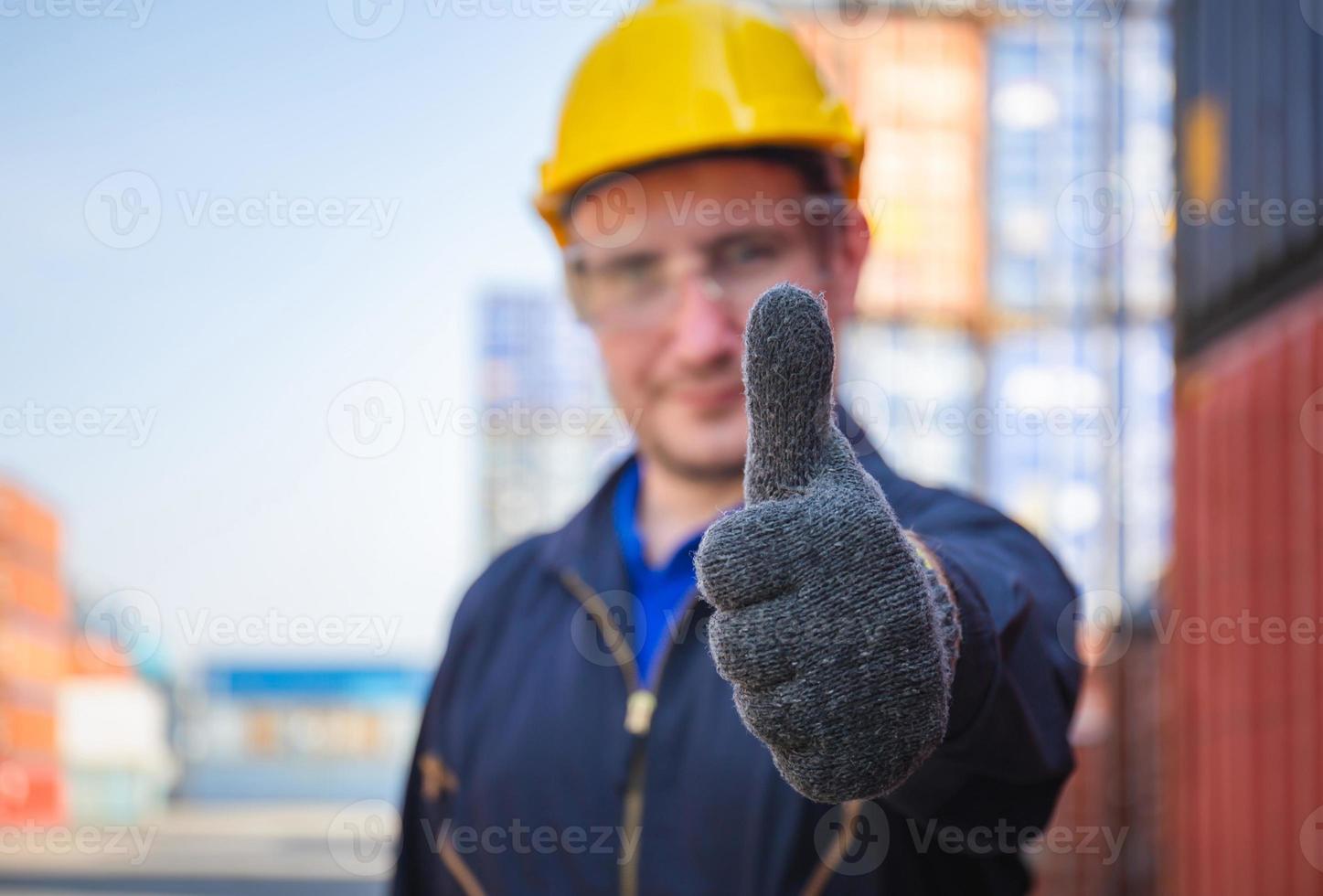 Cheerful factory worker man smiling with giving thumbs up as sign of Success photo