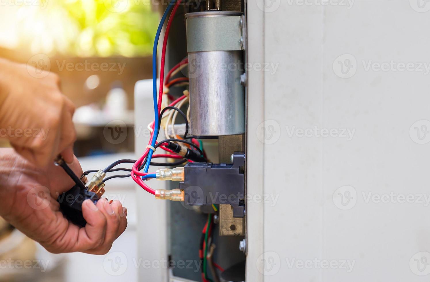 Close up of Air Conditioning Repair, repairman fixing air conditioning system, changing magnetic contactor photo