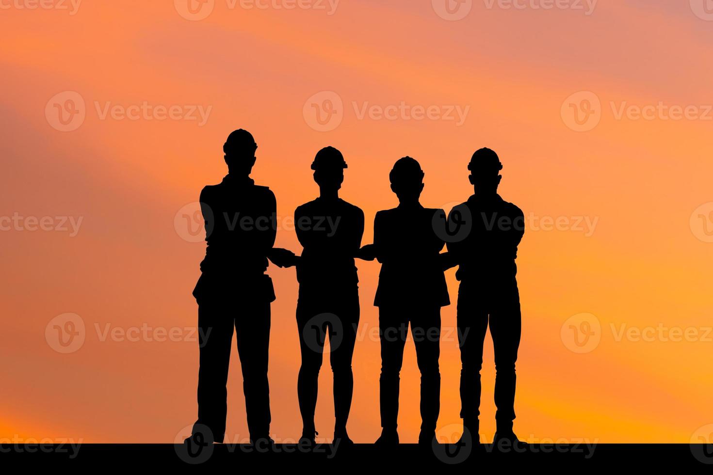 Silhouettes of Business people engineer and worker team meeting holding hands together in line, Success Connection and Teamwork Concepts photo