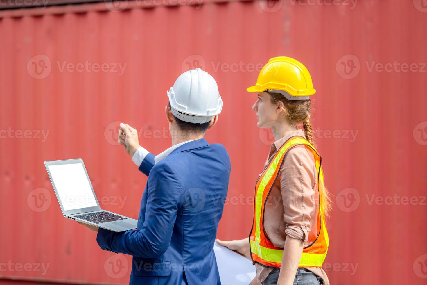Engineer team with laptop and clipboard checklist checking containers box from cargo, Logistic and teamwork concept photo
