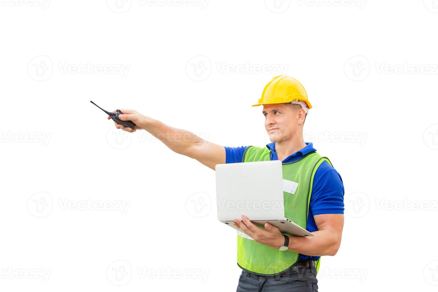 Factory worker in hardhat and safety vest holding two-way radio and laptop, Engineer man with clipping path on white background photo