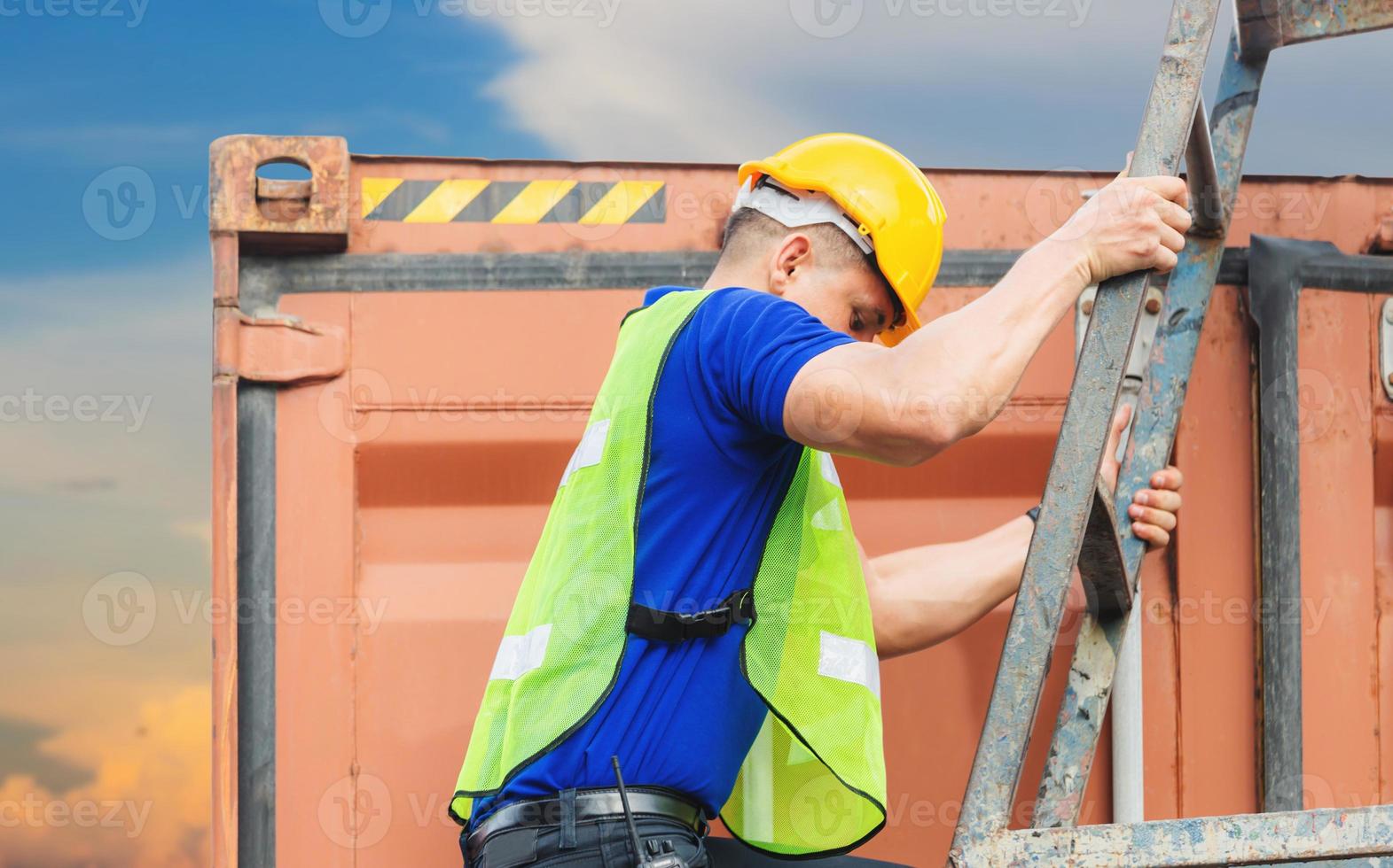 Worker go up climbing the ladder to the container photo