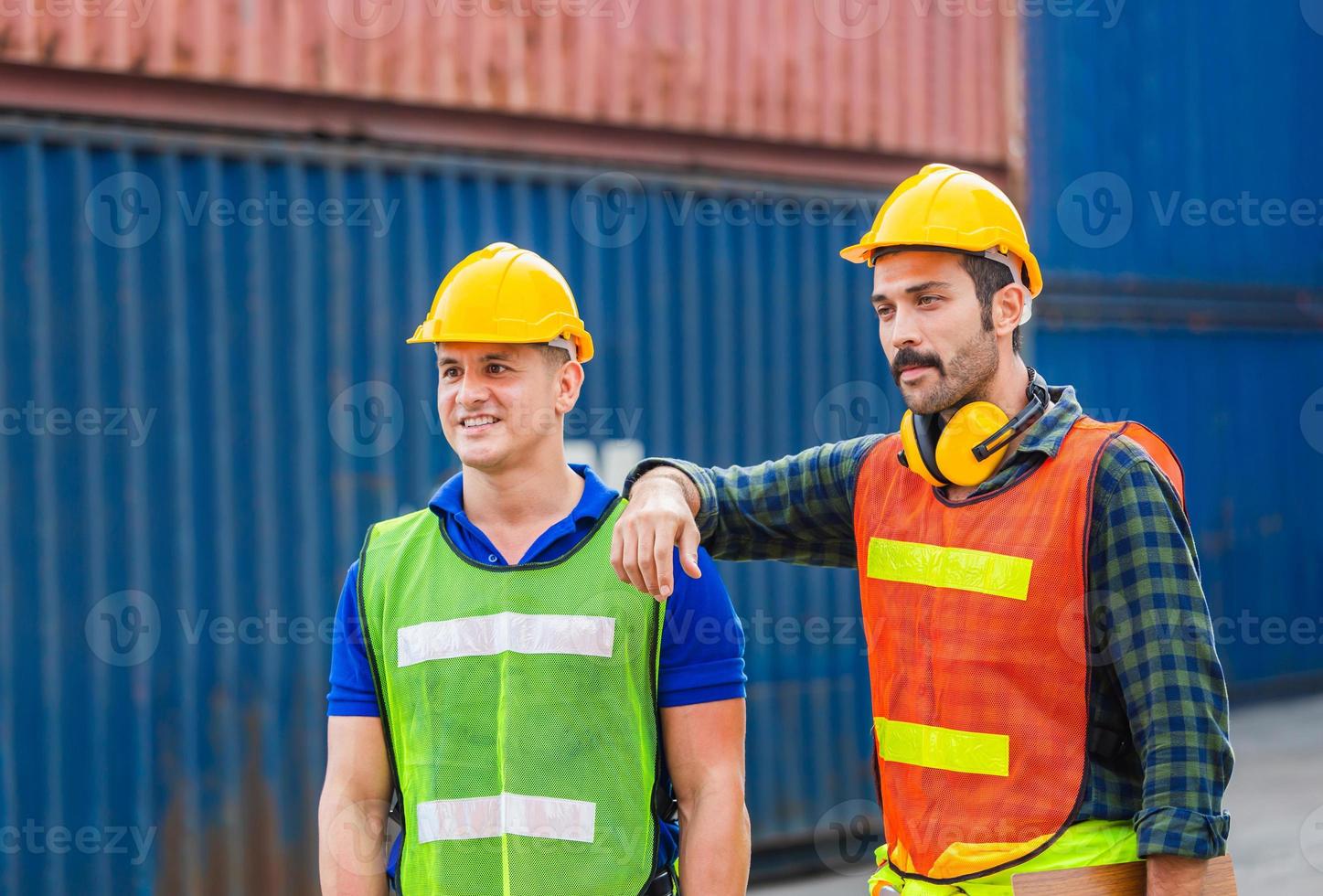 Happy Engineer and worker team checking containers box from cargo with blurred background, Teamwork concept photo