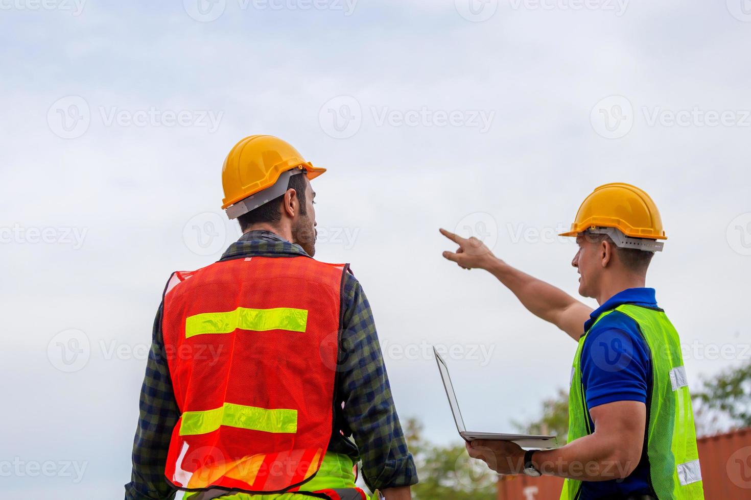 Engineer and factory worker team checking containers box from cargo with blurred background, Teamwork concept photo
