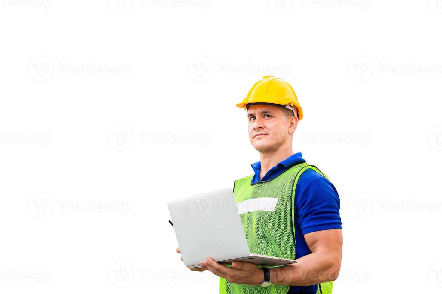 Worker man in hard hat and safety vest holding laptop with clipping path on white background photo