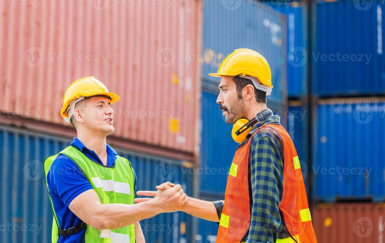 Engineer and foreman worker handshake with blurred construction site, Success and Teamwork concept photo