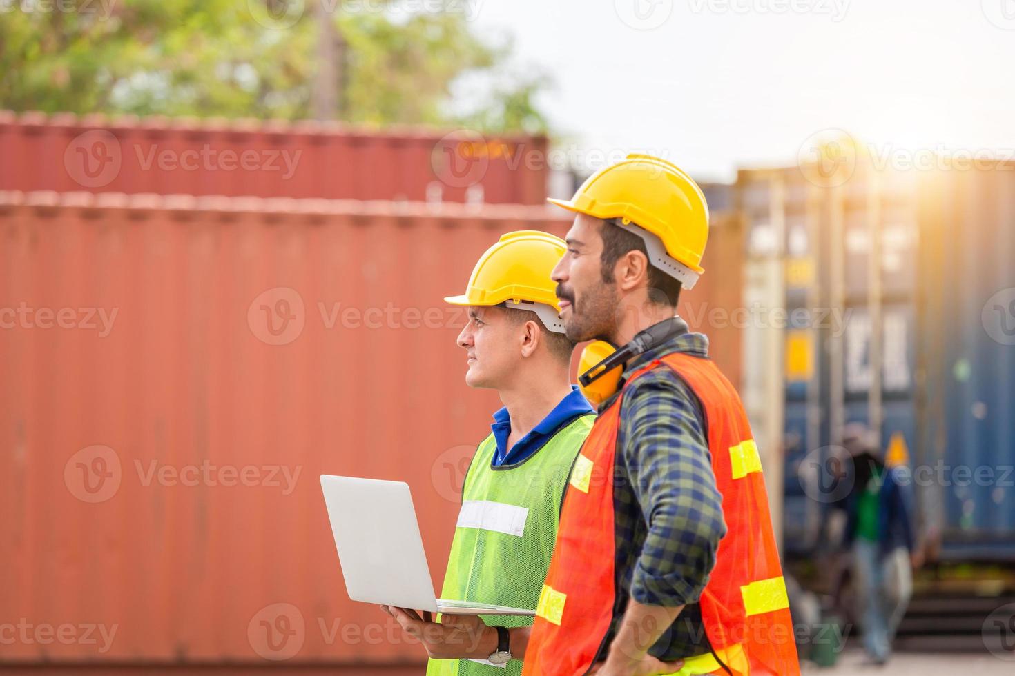 Engineer and factory worker team checking containers box from cargo with blurred background, Teamwork concept photo