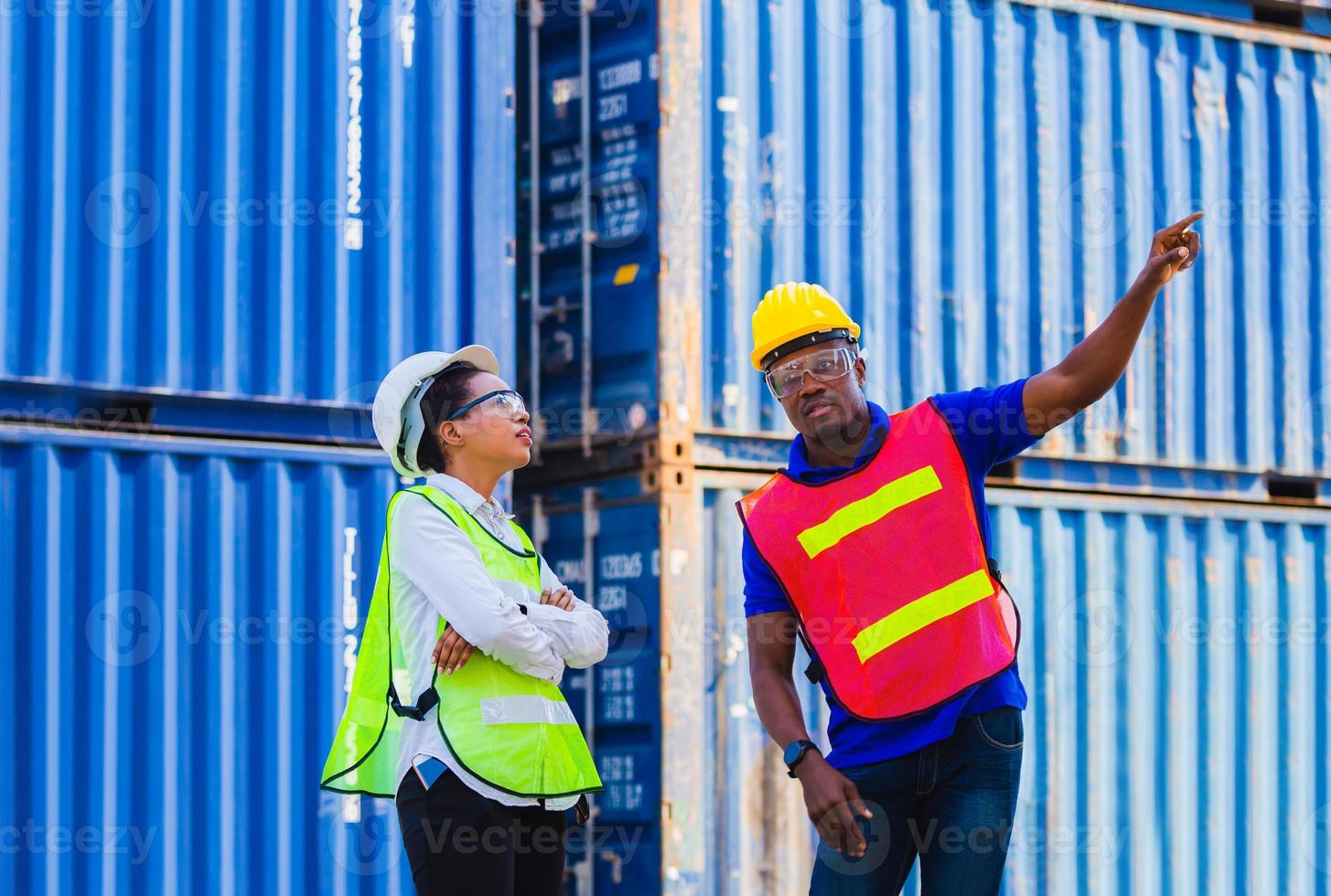 Female engineer checking containers box with worker man from cargo photo
