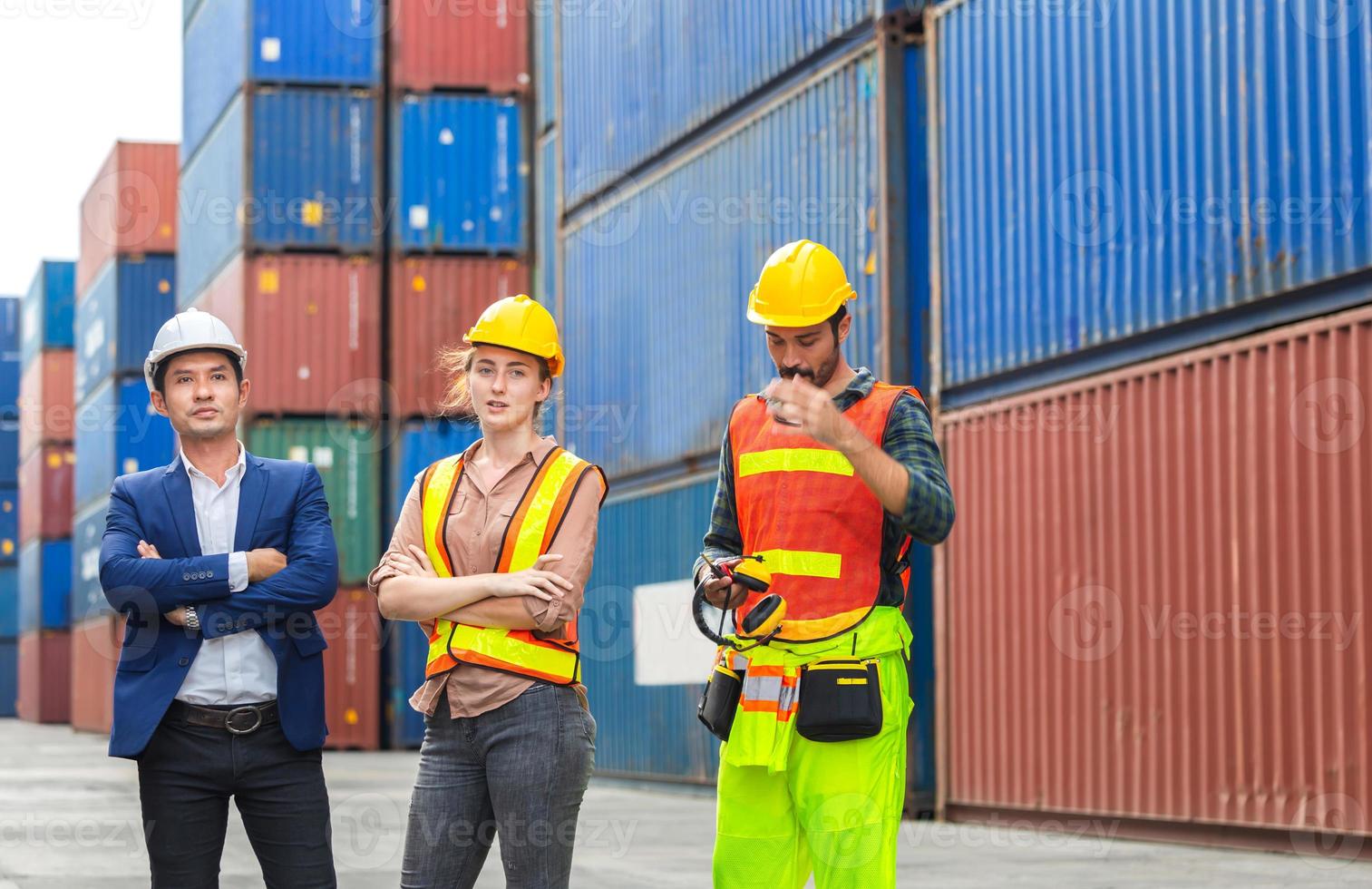 Engineer and foreman worker team in hardhat and safety vest at cargo container photo