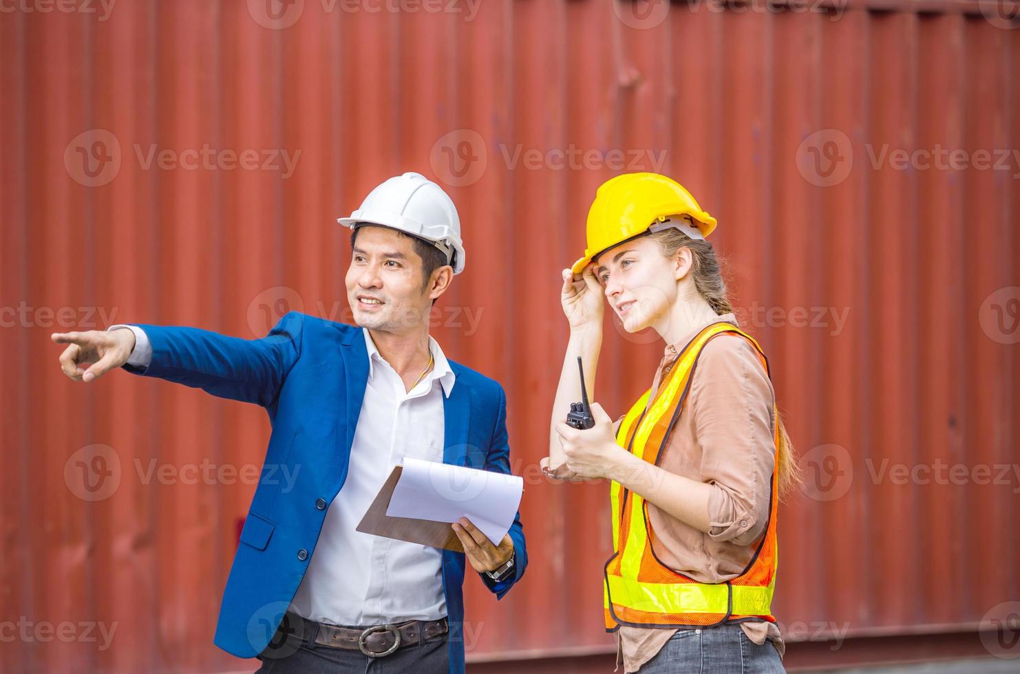 Engineer and foreman worker team checking containers box from cargo, Logistic and teamwork concept photo