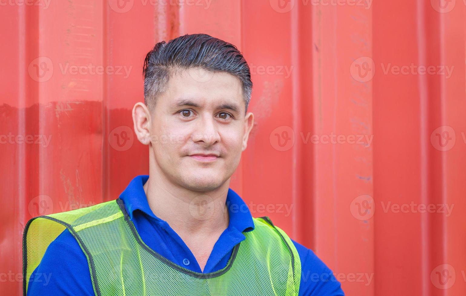 Cheerful factory worker man smiling and looking at camera with joy, Happiness concept photo