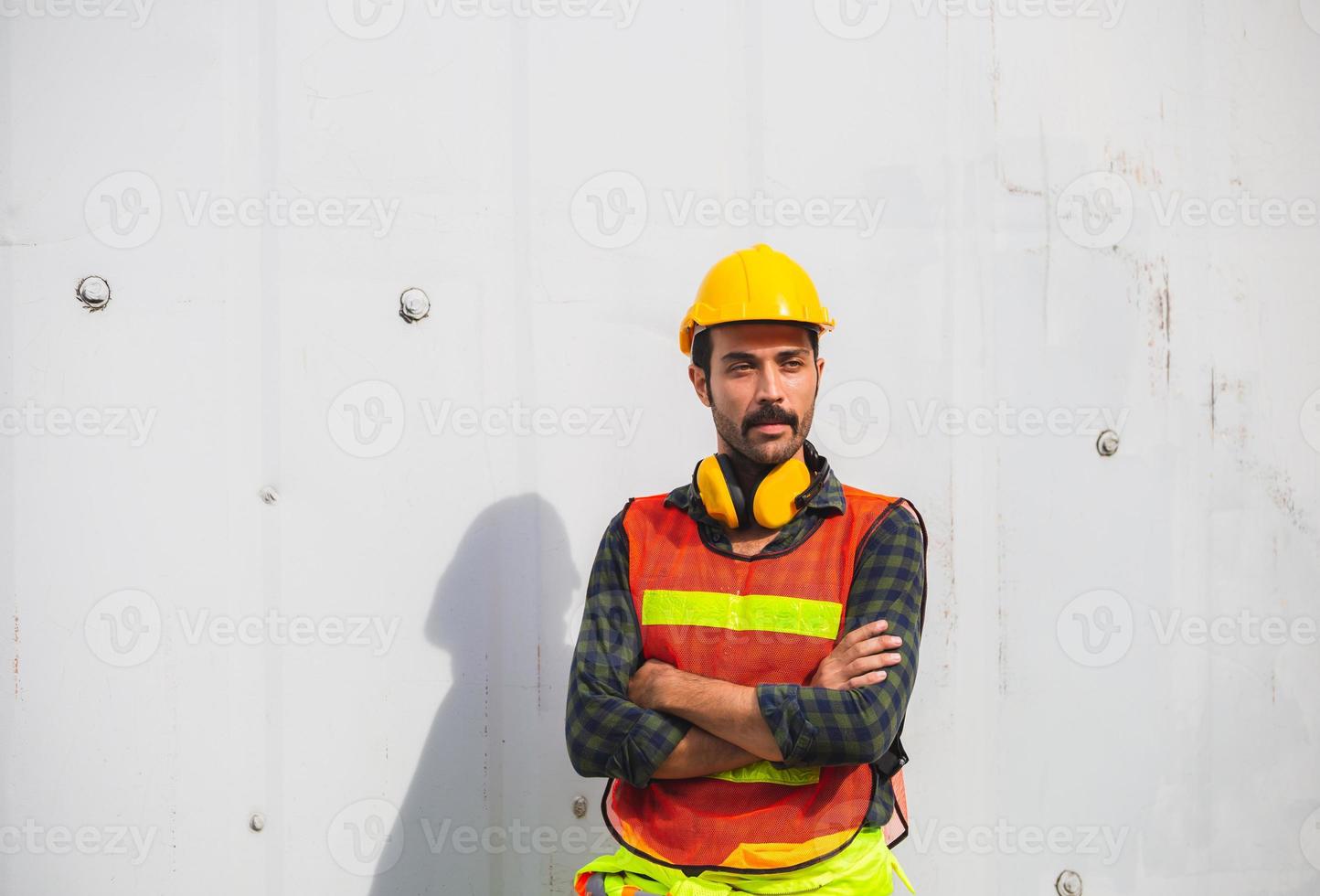 Portrait of Worker man standing with arms crossed at containers cargo photo