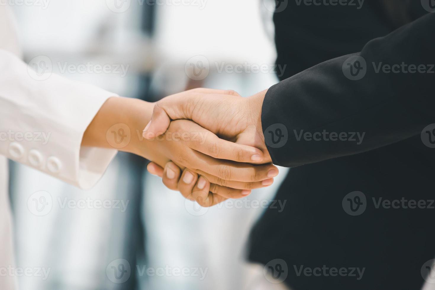 Success and Happiness Team Concept, Businessman and Businesswoman handshake finishing up a meeting photo