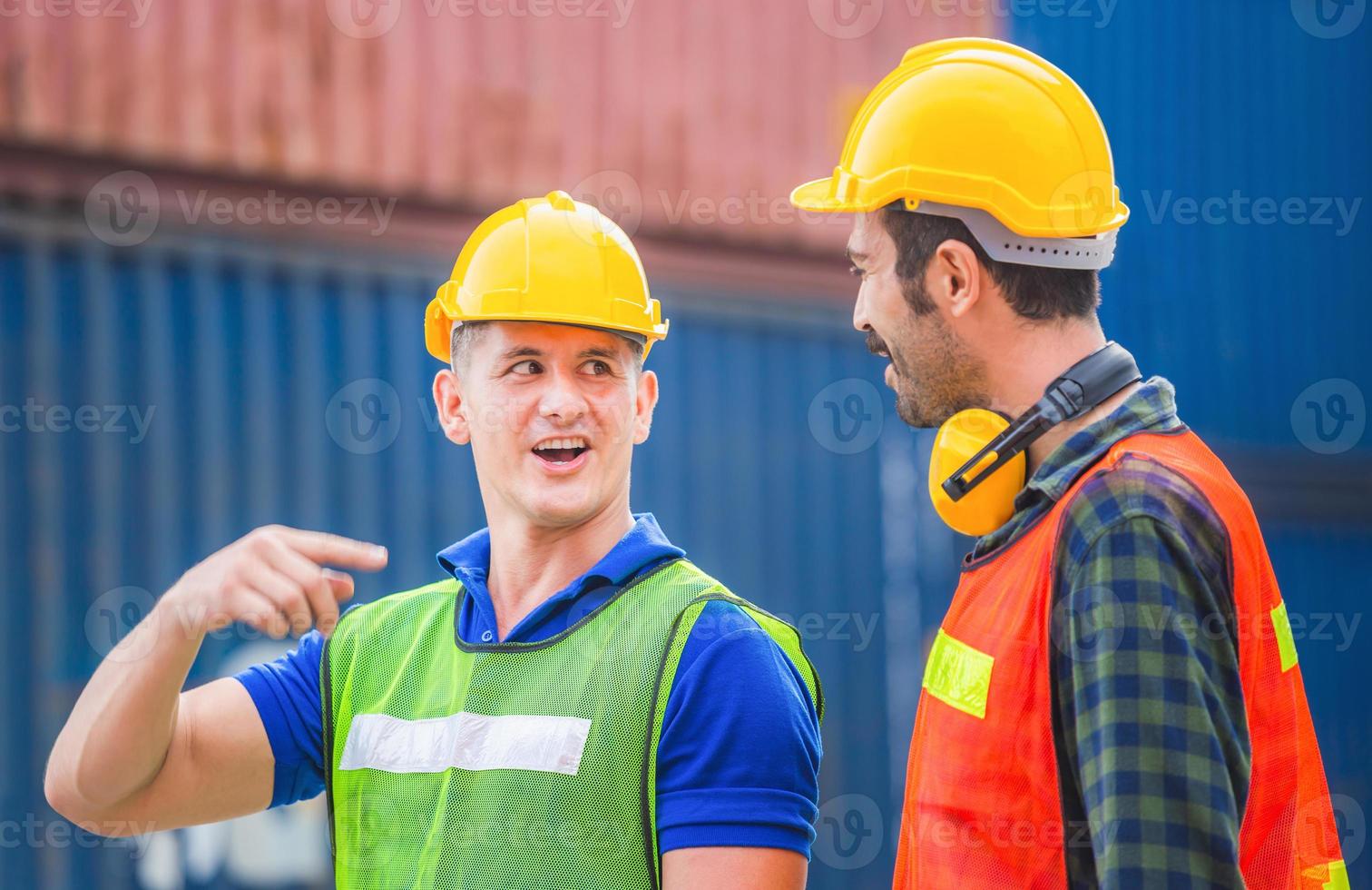 Happy Engineer and worker team checking containers box from cargo with blurred background, Teamwork concept photo