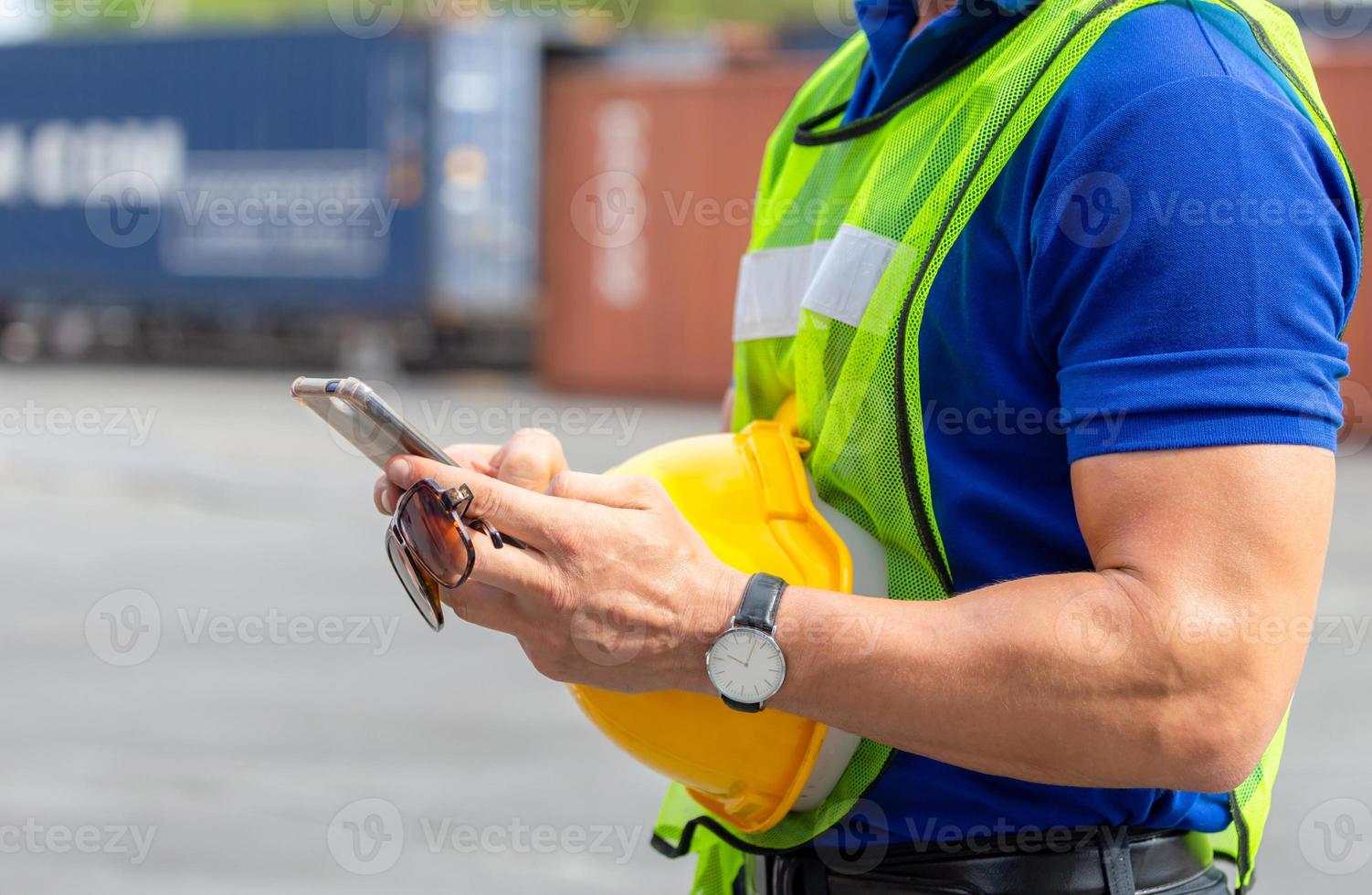 Engineer man uses mobile phone, Industrial worker using mobile smartphone in industry containers cargo photo