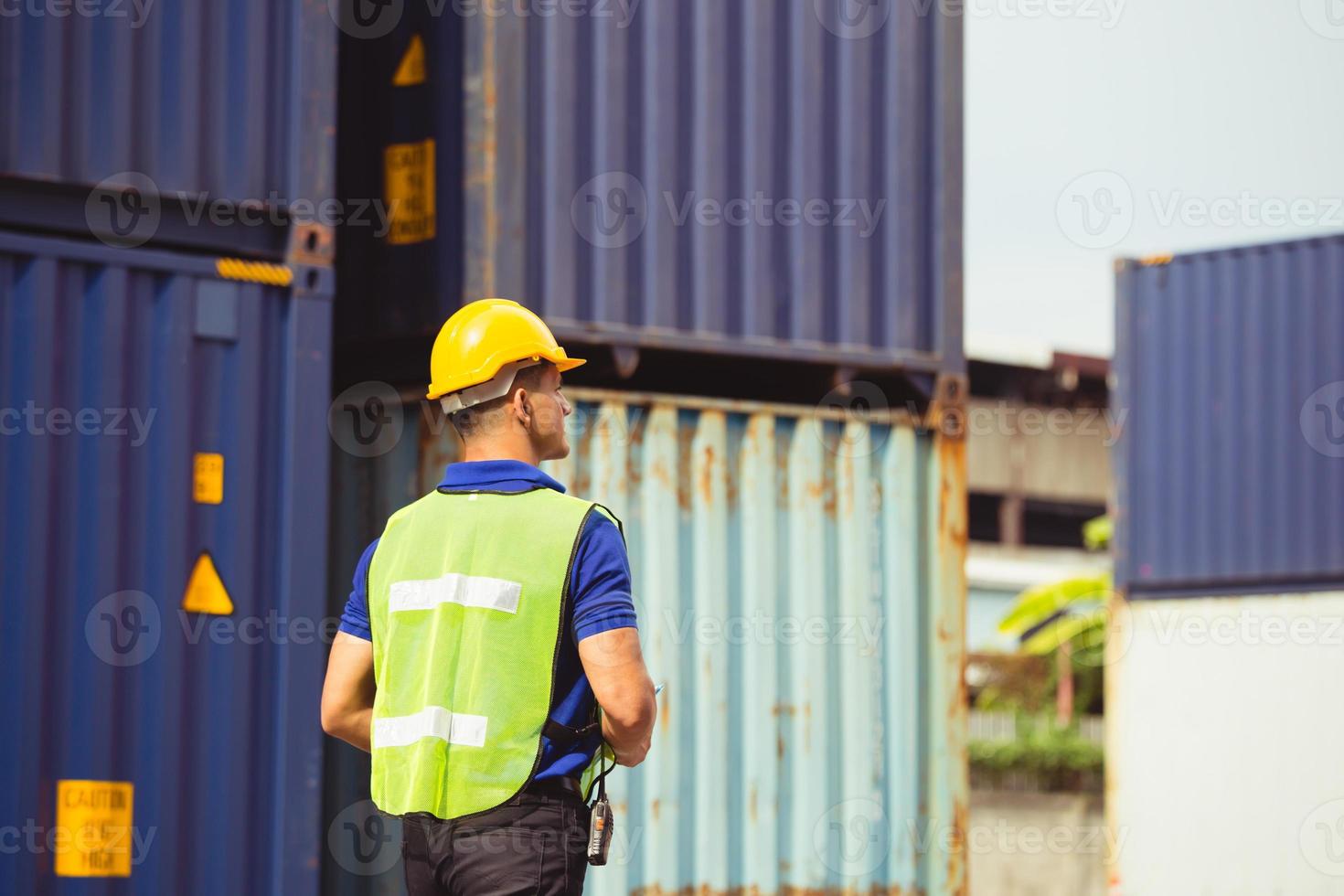 Factory worker man checking containers box from cargo photo