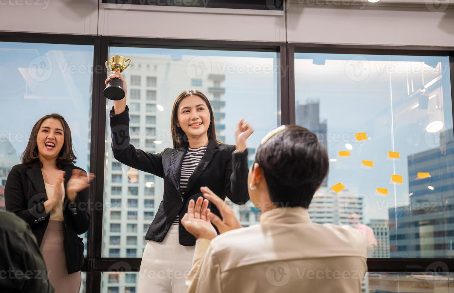 Business woman holding award trophy at meeting room, Celebration success happiness team concept photo