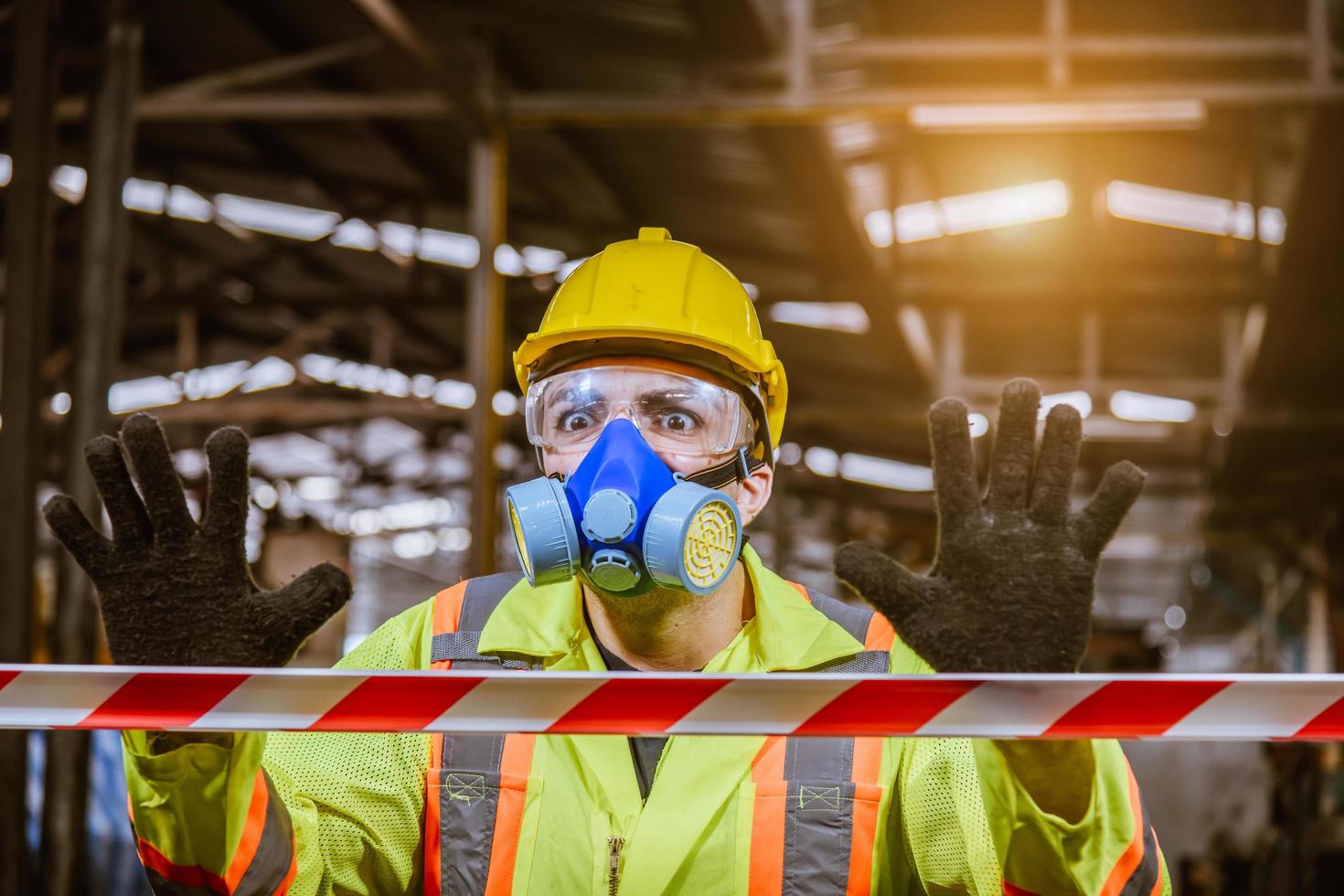 Engineer industry wearing safety uniform ,black gloves ,gas mask feel suffocate when under checking chemical tank in industry factory work. photo
