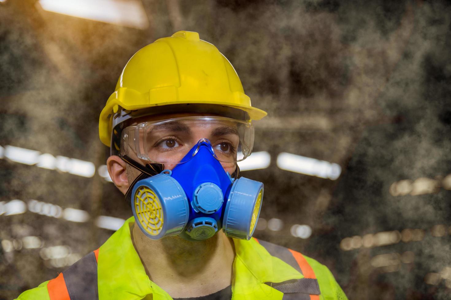 Engineer industry wearing safety uniform ,black gloves ,gas mask feel suffocate when under checking chemical tank in industry factory work. photo